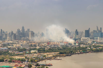 Panoramic view of buildings in city against sky