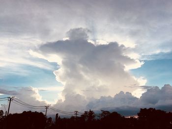 Low angle view of silhouette trees against sky