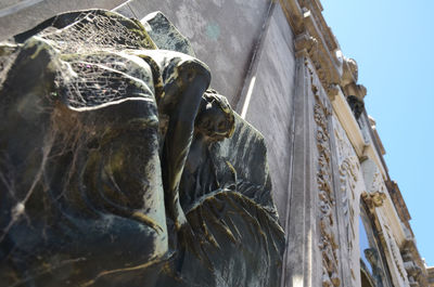 Low angle view of statue against sky