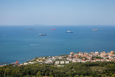 Aerial view of empty cargo ships near the coast with calm seas.