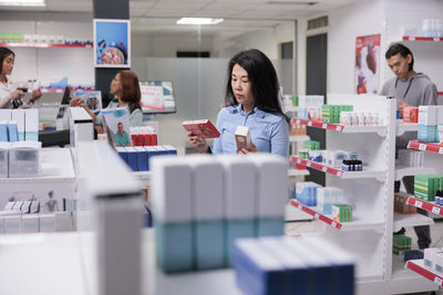 Portrait of young woman standing in store