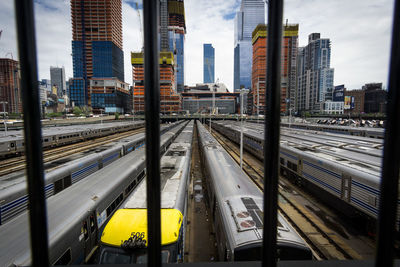 Railroad tracks in city against sky