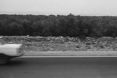 Close-up of car on road against sky