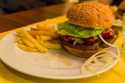 Close-up of burger and vegetables on table