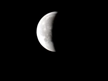 Low angle view of half moon against sky at night