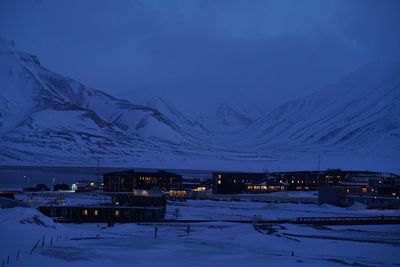 Snow covered mountains against sky at dusk