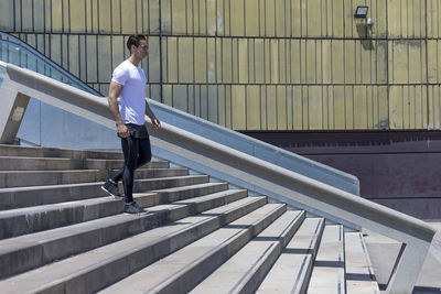 Side view of young man on staircase