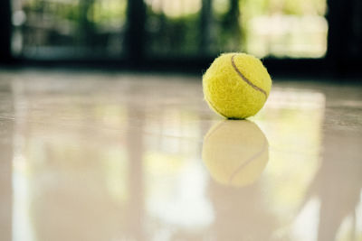 Close-up of tennis ball on floor