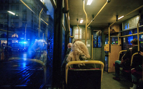 Woman in bus at night in city