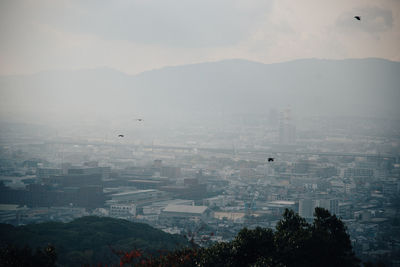 Aerial view of cityscape against sky