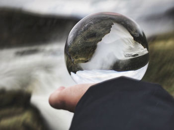 Close-up of human hand holding ball