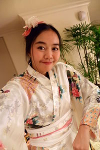 Portrait of smiling young woman in kimono