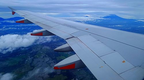Aerial view of airplane wing over landscape