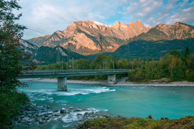 Scenic view of bridge over mountains against sky