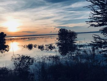 Scenic view of lake against sky during sunset