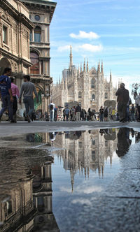 Milan cathedral reflecting on puddle