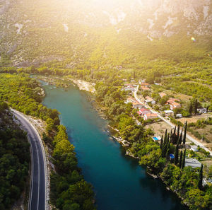 High angle view of canal amidst trees in city