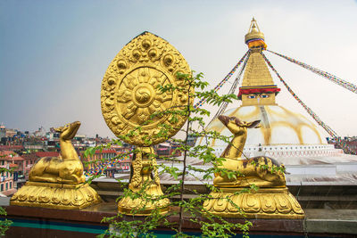 Statue of temple against building