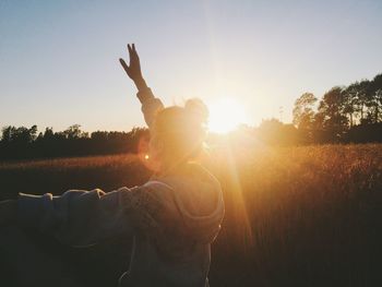 Woman on field against sky