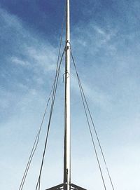 Low angle view of suspension bridge against blue sky