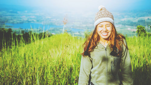 Portrait of smiling young woman standing in farm