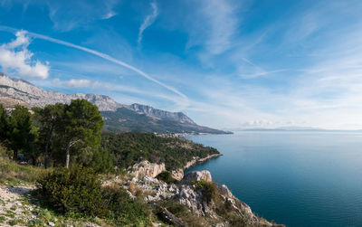 Scenic view of sea and mountains against sky