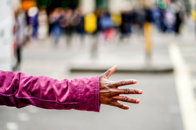 Close-up of hand on pink leaf