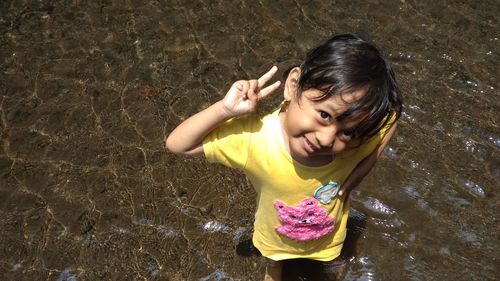 High angle portrait of girl standing in water