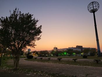 View of city street against clear sky at sunset