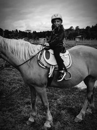 Portrait of man riding horse