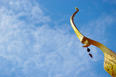 Low angle view of statue against blue sky