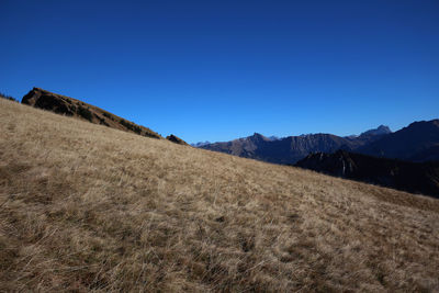 Scenic view of mountains against clear blue sky