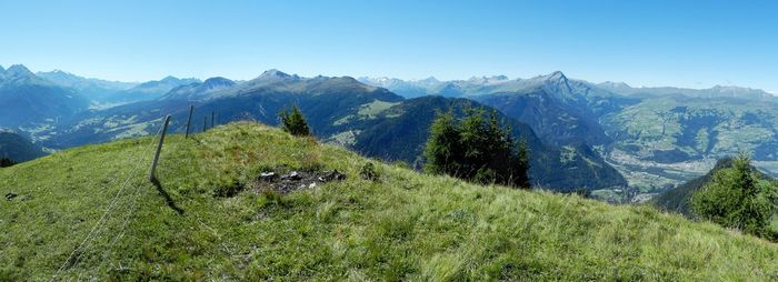 Scenic view of mountains against blue sky