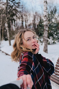 Portrait of young woman in snow