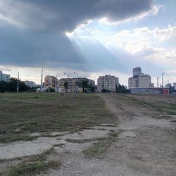 Buildings against cloudy sky