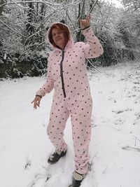 Full length of girl standing on snow covered field