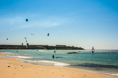 People kiteboarding in sea