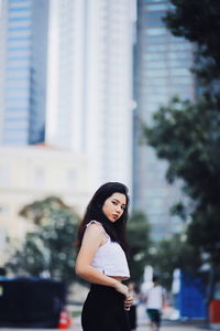 Portrait of woman standing in city