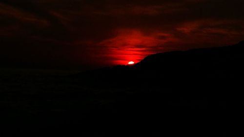 Scenic view of silhouette landscape against sky at sunset