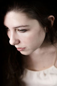 Close-up portrait of beautiful young woman looking away