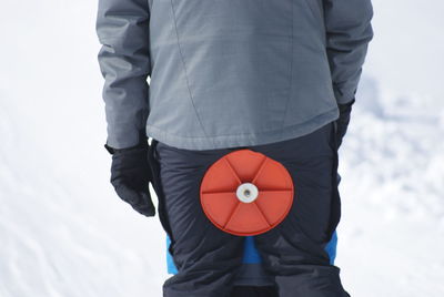 Rear view of man standing on snow covered land