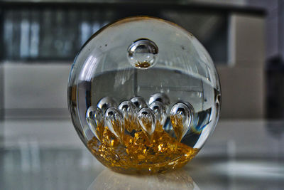 Close-up of crystal ball on glass table