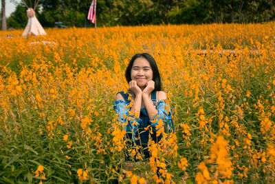 A cheerful girl in a yellow flower field