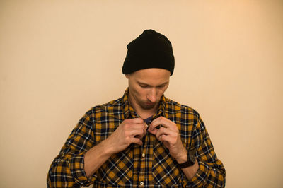 Young man wearing mask against white background