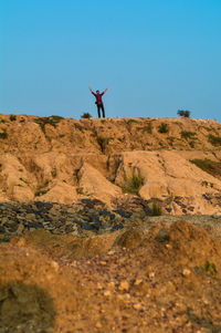 Man standing on mountain against clear sky