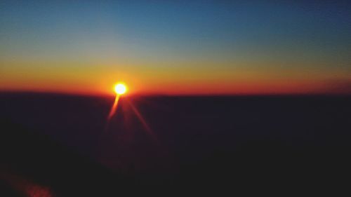 Silhouette landscape against sky during sunset