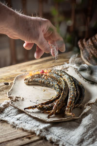 Traditional latvian cousins baked lamprey in rustic kitchen interior
