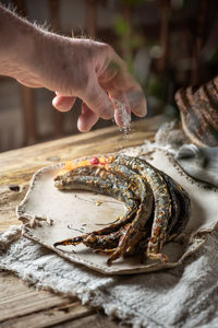 Cropped hand of person preparing food