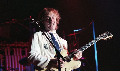 Full length of man playing guitar