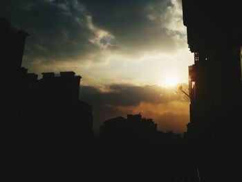 Buildings in city at sunset